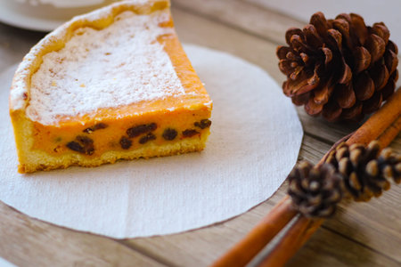 A piece of sweet pie made of cottage cheese and pumpkin, sprinkled on top with powdered sugar