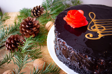 Chocolate cake with red rose and music staff