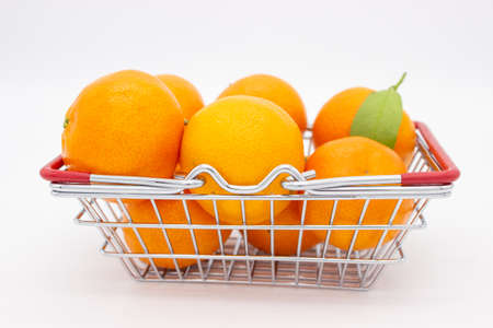 Sicilian oranges and tangerines in metal basket on white backgroundの写真素材
