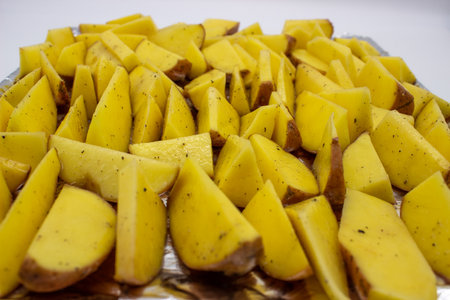 Baked potatoes with large pieces on plateの写真素材