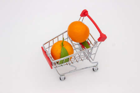 Sicilian oranges and tangerines in metal basket on white backgroundの写真素材