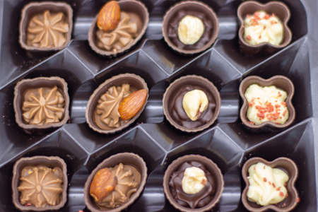 Few chocolates in open brown boxの写真素材