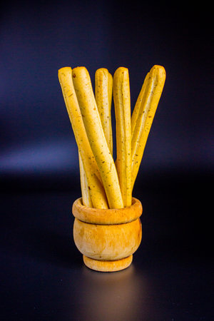 Italian breadsticks grissini on dark background