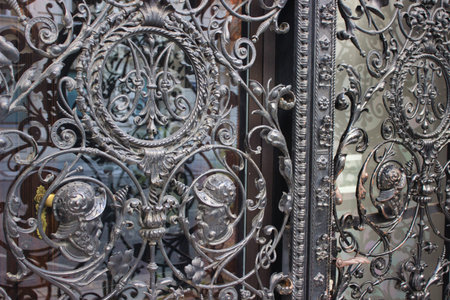 Intricately designed wrought iron gate featuring detailed historical warrior figures and floral...