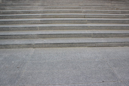 Close up of granite stone stairs surface showing clean lines and texture of urban architectural...