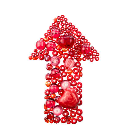 Layout of red beads and marbles isolated on a white background vertically in the shape of an arrow pointing up.の写真素材