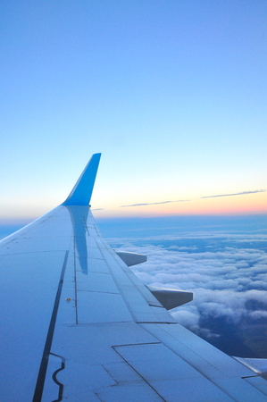 Clouds and sky as seen through window of an aircraftの写真素材
