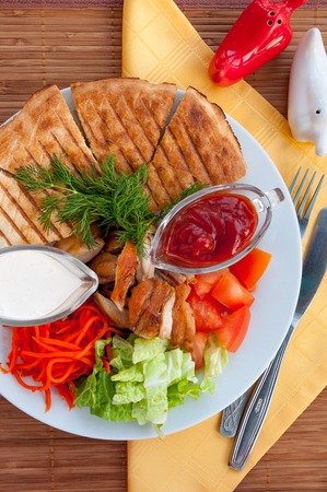 Doner kebab on a plate with vegetables and saladの写真素材