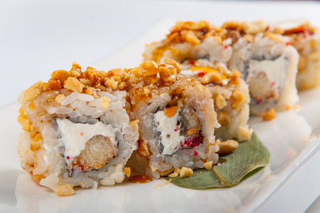 sushi roll with tuna, Philadelphia cheese, flying fish caviar, peanutsの写真素材