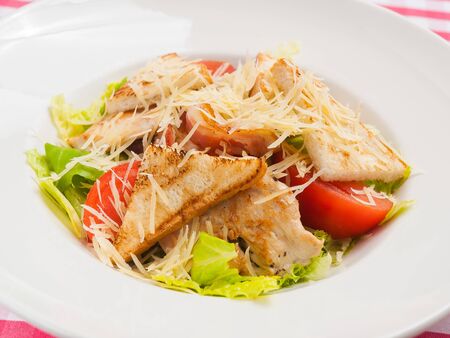 tasty classic Caesar salad on a white plateの写真素材