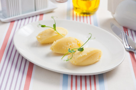 tasty mashed potatoes, beautifully laid out on a white plate