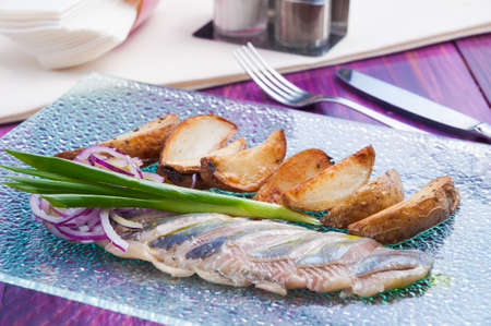 tasty herring of weak salt with slices of baked potatoesの写真素材