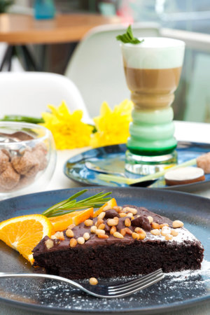 tasty chocolate cake with nuts and a latte with mint syrup. Concept: delicious breakfasts