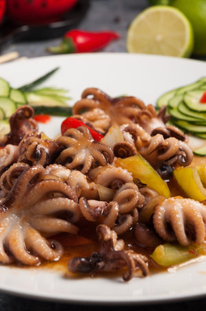 tasty small octopuses on a plate in a sweetly spicy sauce. Chinese cuisine. Close up. Selected focus
