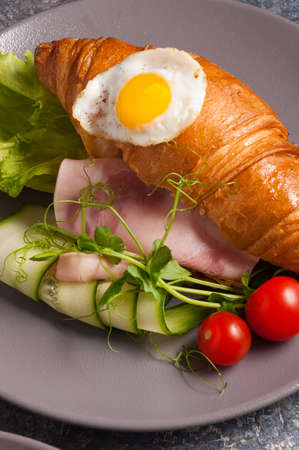 tasty croissant with ham, cucumber and egg. Concept: Breakfastの写真素材