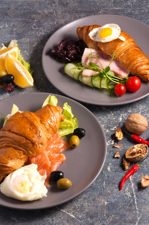 tasty croissant with smoked salmon and the croissant with ham. Concept: Breakfastの写真素材