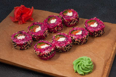 sushi rolls with salmon cream cheese and beetroot riceの写真素材