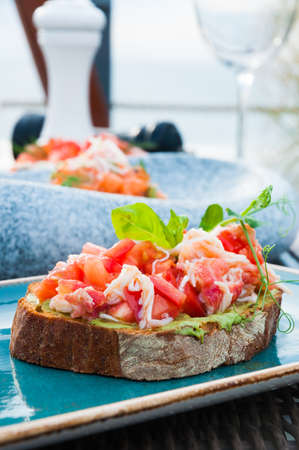 tasty brochette with cream cheese and salmon in the restaurantの写真素材