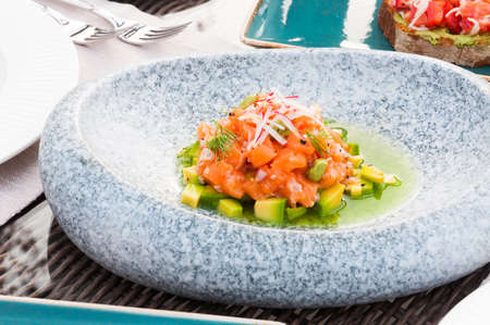 tasty salmon tartare with avocado in the restaurantの写真素材