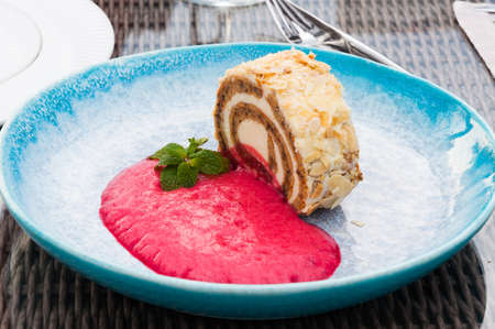 tasty carrot roll with raspberry mousse in a restaurantの写真素材