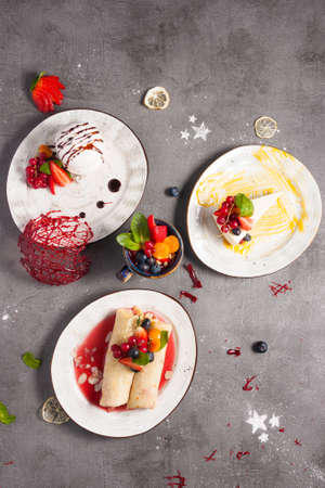tasty set of desserts: meringue, cheesecake, pancakes with strawberries. Top viewの写真素材
