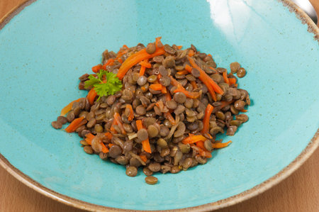 tasty lentils with carrots on a plate. close up. good nutritionの写真素材