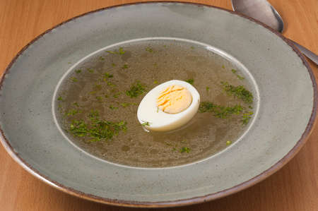 tasty broth with egg and dill. close upの写真素材