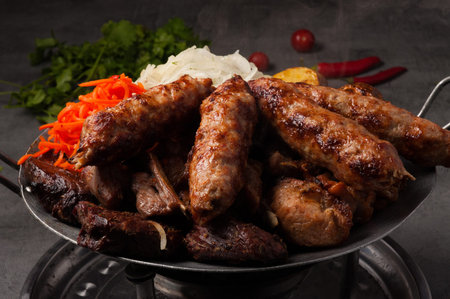 tasty Kazan kebab-assorted meat, heated on the fire. Traditional asian dish