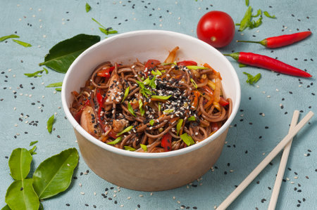tasty buckwheat noodles with chicken and vegetables in a craft bowlの写真素材