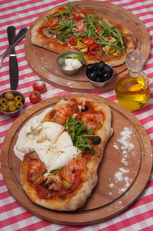 two tasty classic Italian pizzas on roman doughの写真素材