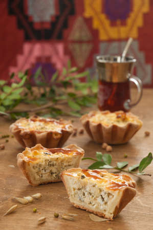tasty baked shortbread tartlets with egg and herbsの写真素材
