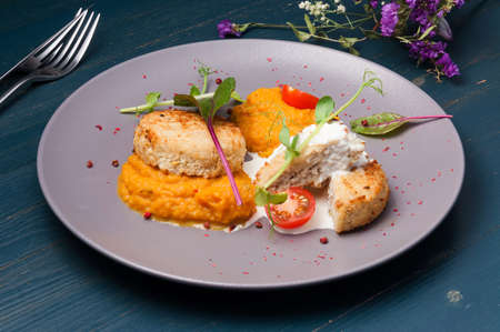 tasty chicken cutlets with pumpkin puree with tomatoes and microgreensの写真素材
