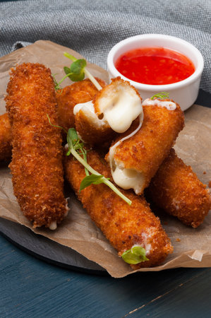 tasty cheese sticks mozzarella fries with hot chili sauceの写真素材
