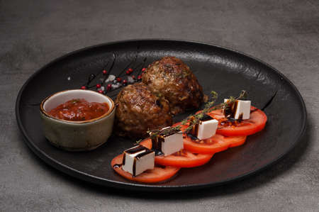 tasty meatballs with tomato sauce, tomatoes and feta cheeseの写真素材