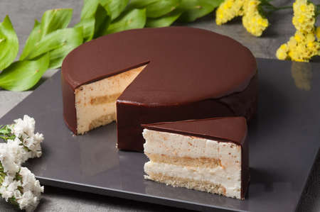 Delicate souffle combined with fragrant almond sponge cake, decorated with natural milk chocolate glazeの写真素材