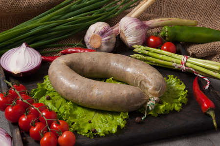 tasty liver sausage with liver decorated with fresh vegetablesの写真素材