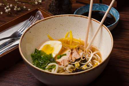 half a bowl of ramen soup with chicken in a cafe. concept: live photoの写真素材