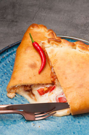tasty hot pizza calzone with mozzarella and tomatoesの写真素材