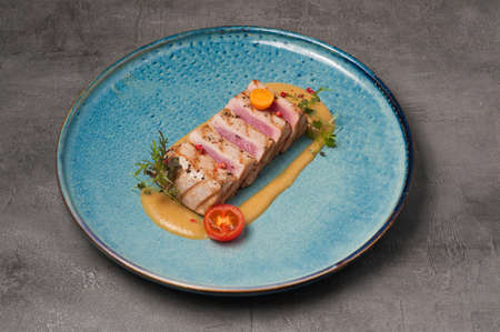 tasty grilled tuna sliced into pieces with mango sauceの写真素材