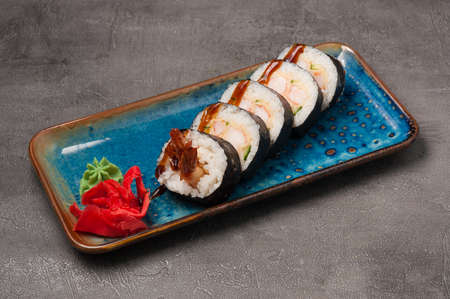 tasty sushi rolls with shrimp tempura and cucumber with unagi sauceの写真素材