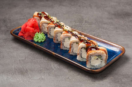 tasty sushi rolls with eel, cream cheese and cucumber with unagi sauceの写真素材