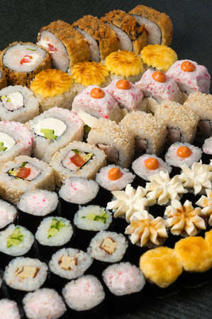 assorted tasty sushi rolls on a gray backgroundの写真素材