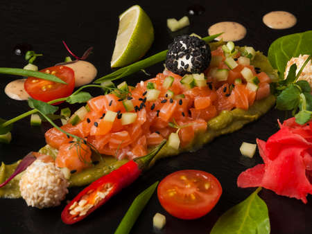 tasty salmon and cucumber tartare with avocado creamの写真素材
