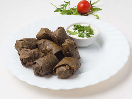 tasty dolma - minced meat in grape leaf with kiferno-garlic sauceの写真素材