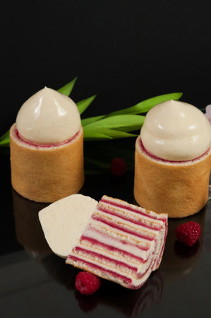 tasty raspberry and creamy ganache cake on a black backgroundの写真素材
