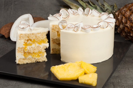 tasty pineapple coconut cake with coconut liqueur on a dark backgroundの写真素材