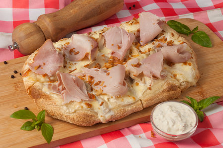 cream-based pizza with ham and mushroomsの写真素材