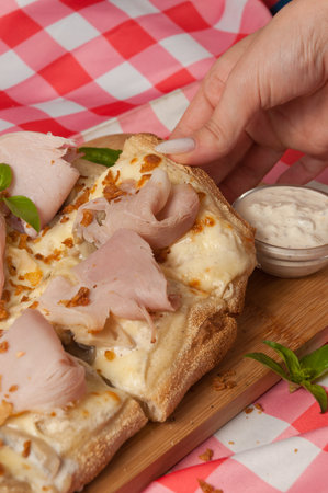 cream-based pizza with ham and mushroomsの写真素材