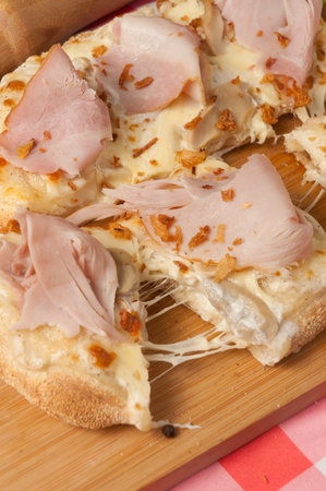cream-based pizza with ham and mushroomsの写真素材