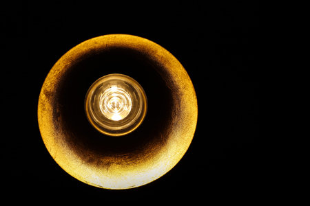Lampshade with gold reflectors and energy saving bulb